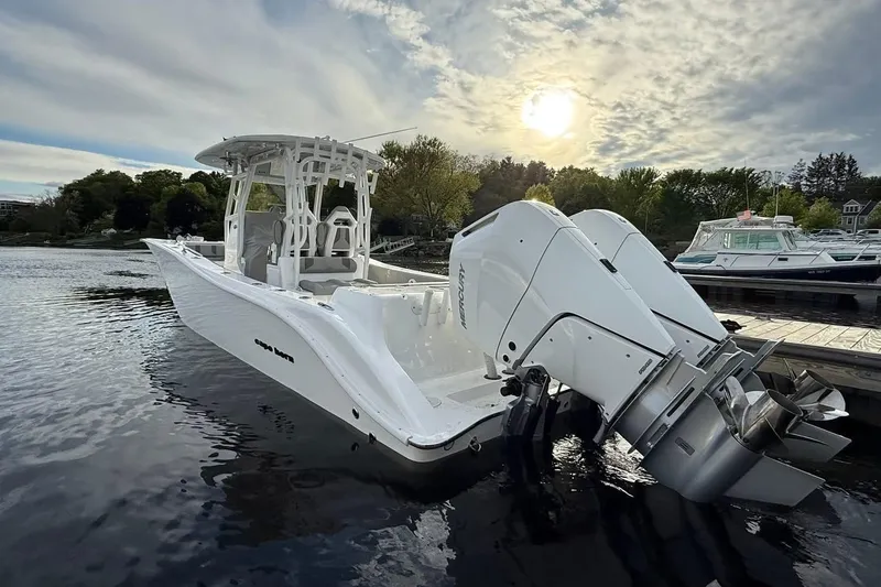 Slide: The Image of 2025 Cape Horn 34 XS boat docked, featuring dual outboard engines under a cloudy sky. - 15