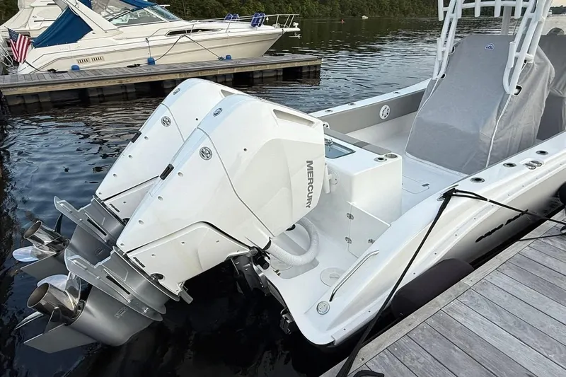Slide: The Image of 2025 Cape Horn 34 XS boat with dual Mercury engines docked by the water. - 11