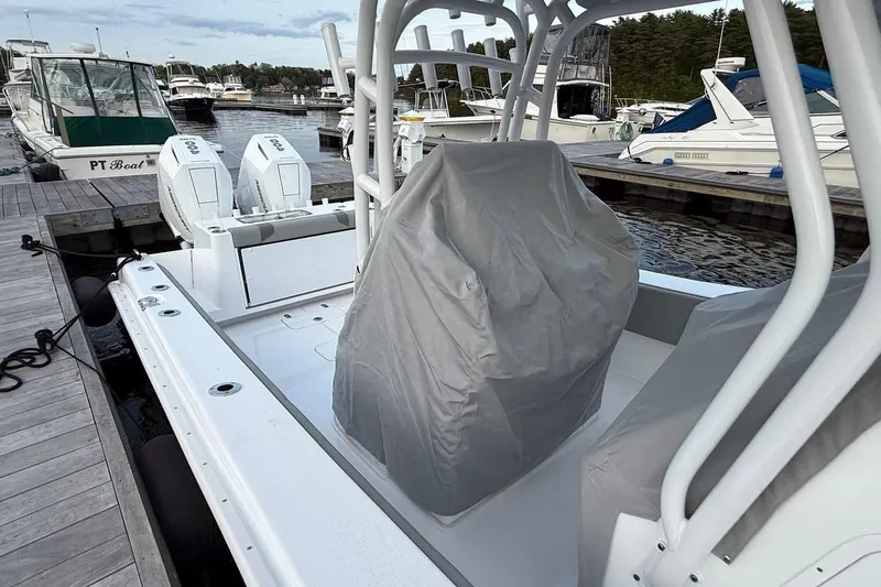 Slide: The Image of 2025 Cape Horn 34 XS boat docked, featuring covered seats and twin engines. - 16