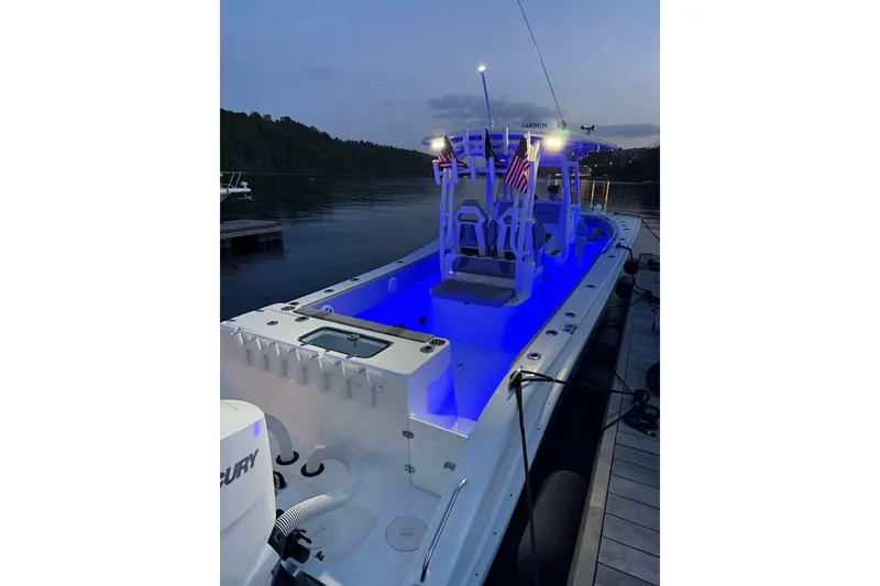 Slide: The Image of 2025 Cape Horn 34 XS boat with blue LED lighting docked at dusk. - 4