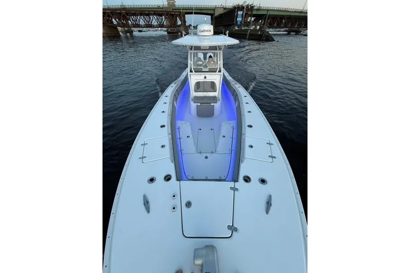 Slide: The Image of 2025 Cape Horn 34 XS boat with blue deck lighting on the water. - 7