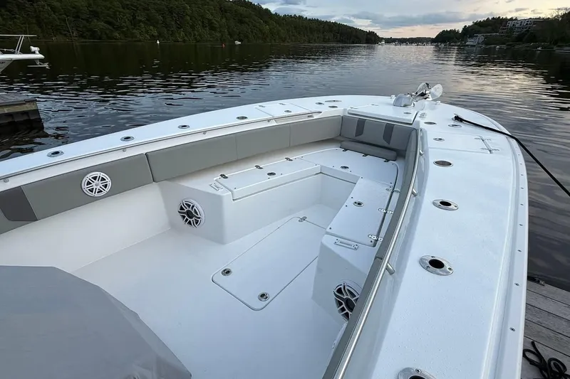 Slide: The Image of 2025 Cape Horn 34 XS boat interior with seating, speakers, and serene water view. - 8