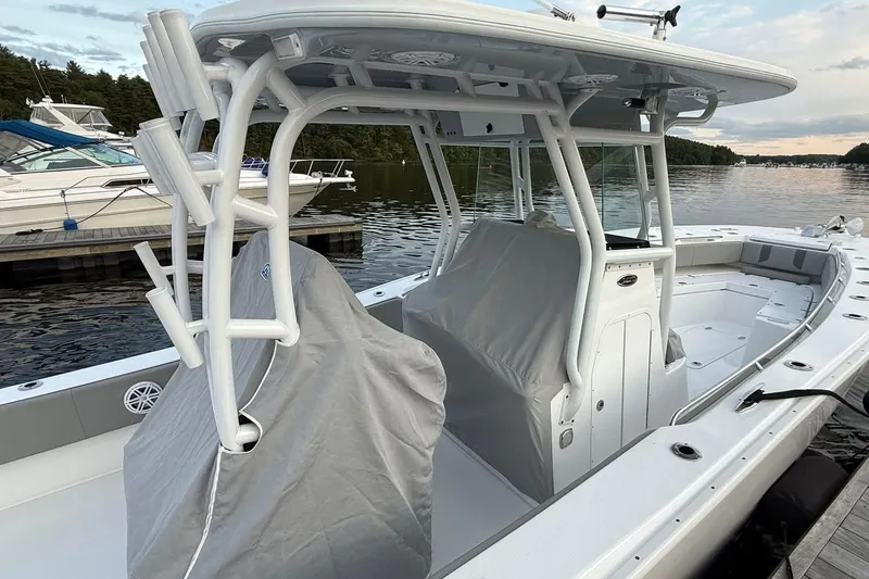 Slide: The Image of 2025 Cape Horn 34 XS boat docked, featuring covered seating and sleek design. - 9