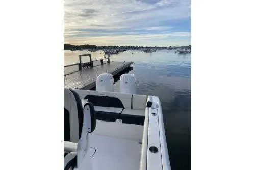 Slide: The Image of 2024 Tidewater 272 LXF boat docked on calm water at sunset. - 13