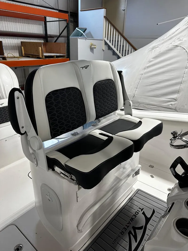Slide: The Image of 2024 Tidewater 272 LXF boat with dual black and white cushioned seats. - 17