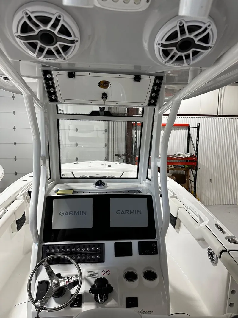 Slide: The Image of 2024 Tidewater 272 LXF boat interior with dual Garmin displays and speakers. - 18