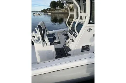 Slide: The Image of 2024 Tidewater 272 LXF boat interior with sleek console and seating on calm water. - 3