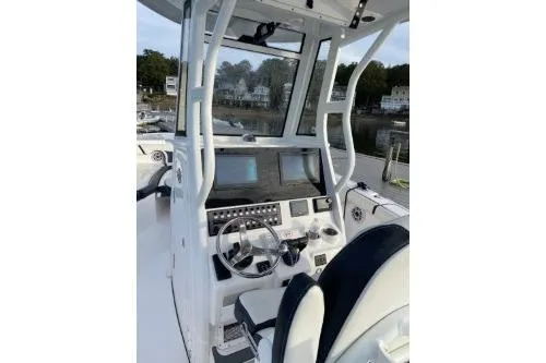 Slide: The Image of 2024 Tidewater 272 LXF boat cockpit with modern controls and steering wheel. - 4