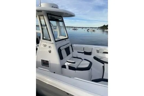 Slide: The Image of 2024 Tidewater 272 LXF boat with sleek design, docked by a serene waterfront. - 5