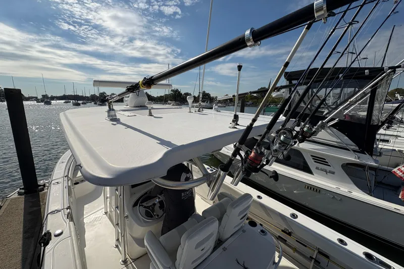 Slide: The Image of 2008 Boston Whaler 320 Outrage boat with fishing rods docked at marina. - 11