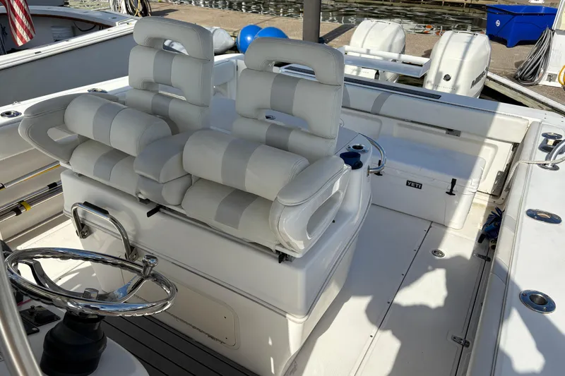 Slide: The Image of 2008 Boston Whaler 320 Outrage boat interior with dual seats and steering wheel. - 17