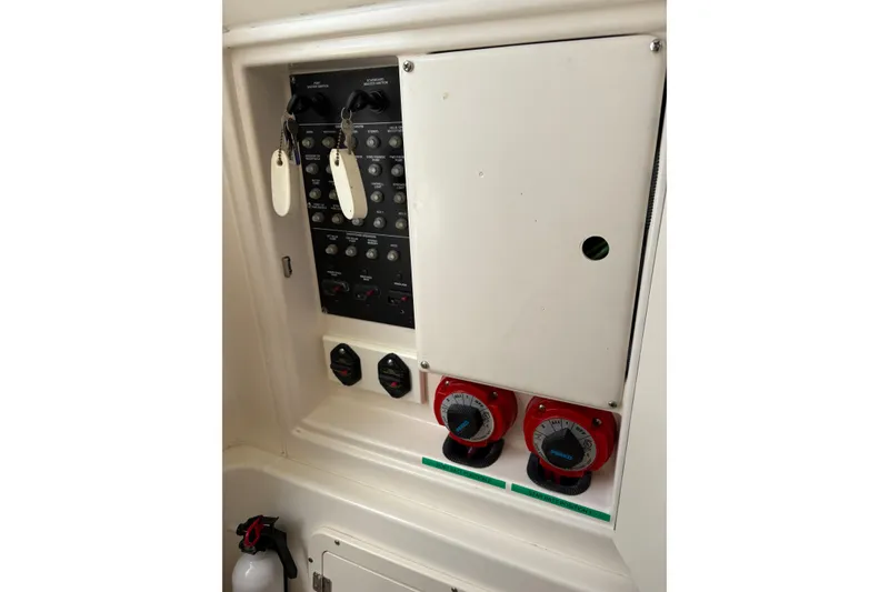 Slide: The Image of Control panel of a 2008 Boston Whaler 320 Outrage boat with switches and dials. - 19