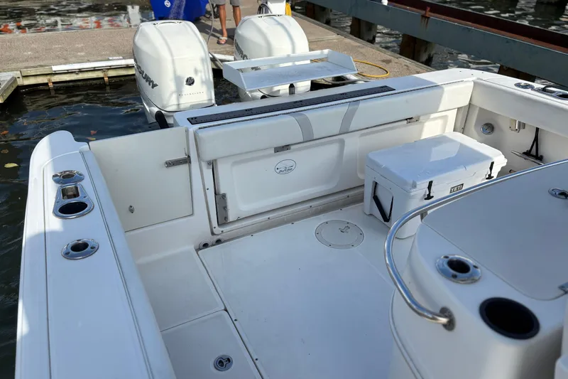 Slide: The Image of 2008 Boston Whaler 320 Outrage boat interior with Yeti cooler and dual Mercury engines. - 6