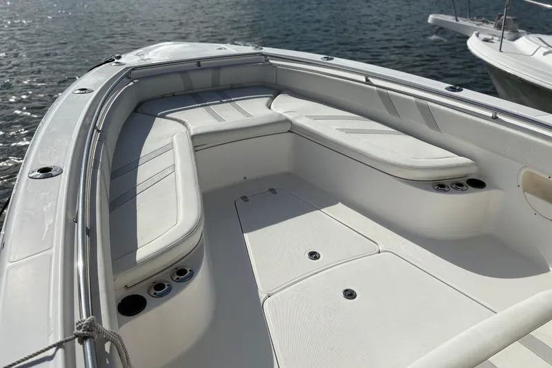 Slide: The Image of 2008 Boston Whaler 320 Outrage boat interior with cushioned seating and cup holders. - 8