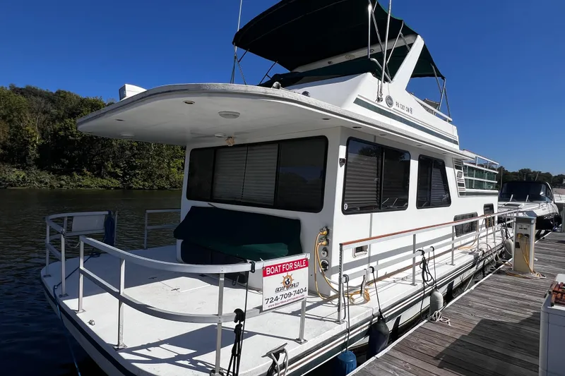 The Image of 1994 Gibson 44 Classic houseboat for sale, docked on a sunny day. - 0