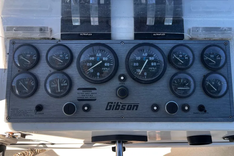 Slide: The Image of Control panel of a 1994 Gibson 44 Classic boat with gauges and switches. - 15
