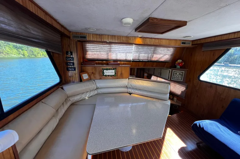 Slide: The Image of Interior of a 1994 Gibson 44 Classic boat with cozy seating and scenic water views. - 16