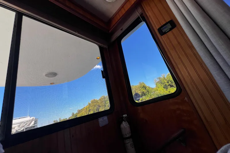 Slide: The Image of Interior view from a 1994 Gibson 44 Classic boat, showing windows and blue sky. - 17
