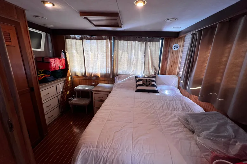 Slide: The Image of Cozy bedroom in 1994 Gibson 44 Classic boat with nautical decor and wood paneling. - 23