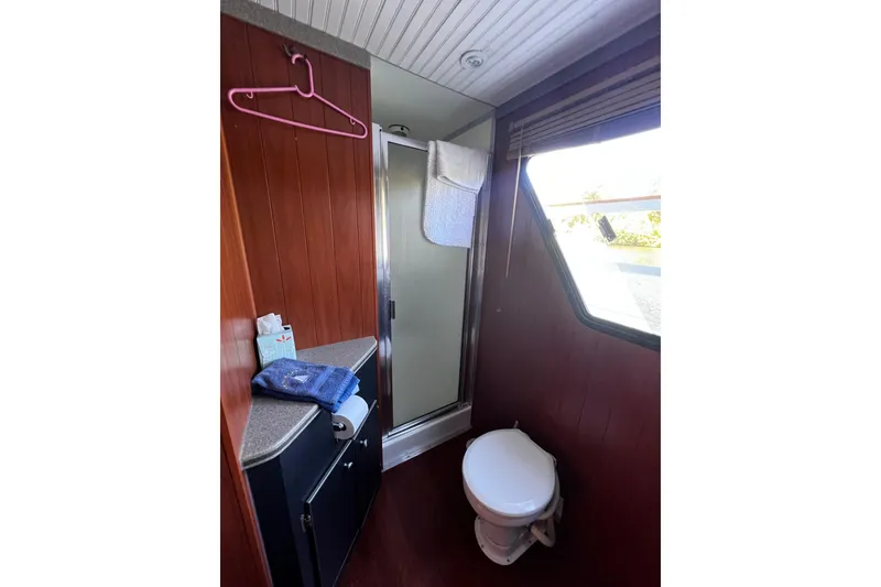 Slide: The Image of Bathroom interior of a 1994 Gibson 44 Classic boat with shower and toilet. - 25