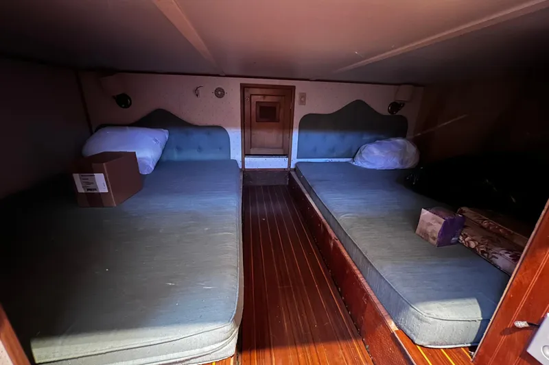 Slide: The Image of Cozy cabin interior of 1994 Gibson 44 Classic with twin beds and wooden flooring. - 28