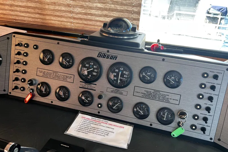 Slide: The Image of Control panel of a 1994 Gibson 44 Classic boat with gauges and switches. - 30