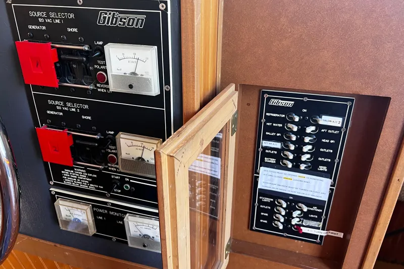 Slide: The Image of Control panels of a 1994 Gibson 44 Classic boat, featuring source selectors and switches. - 31