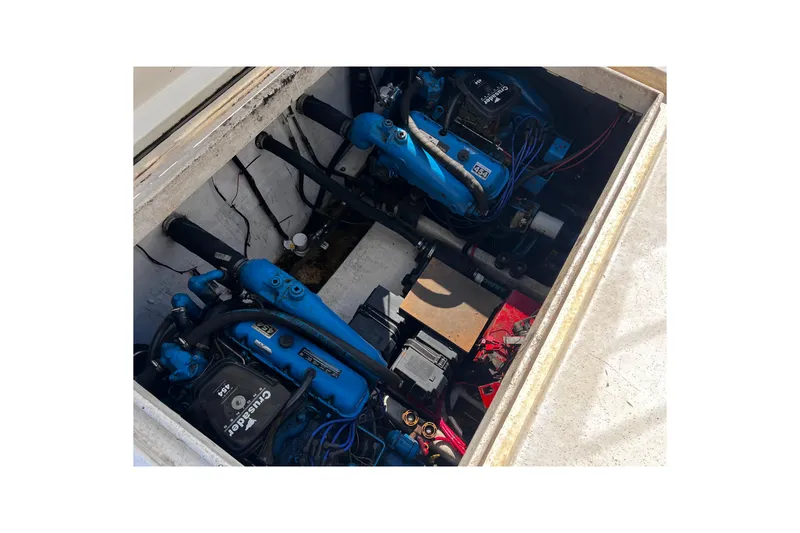 Slide: The Image of Engine compartment of a 1994 Gibson 44 Classic boat, featuring dual blue engines. - 34