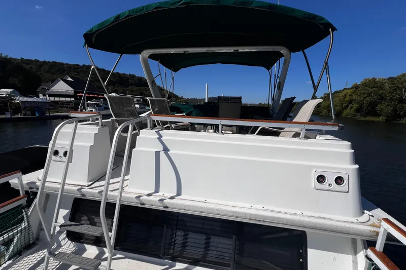 Slide: The Image of 1994 Gibson 44 Classic boat with canopy, docked on a sunny day. - 9