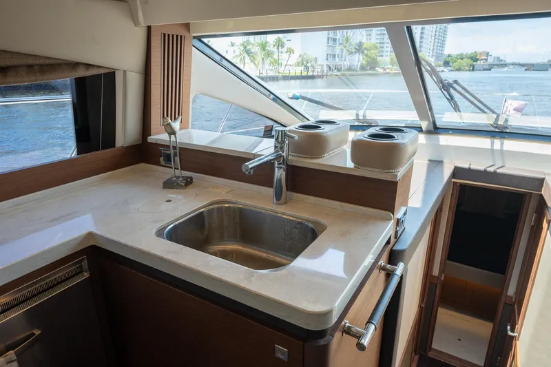 Slide: The Image of 2016 Sea Ray 510 Fly yacht kitchen with sink and waterfront view. - 21
