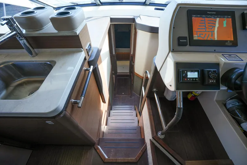 Slide: The Image of 2016 Sea Ray 510 Fly yacht interior with stairs, sink, and navigation system. - 22