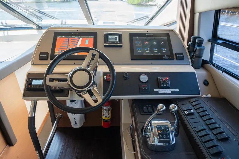 Slide: The Image of Helm station of 2016 Sea Ray 510 Fly yacht with modern controls and navigation screens. - 24