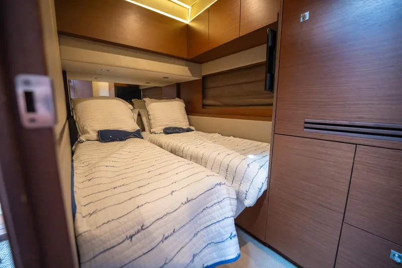 Slide: The Image of 2016 Sea Ray 510 Fly cabin with twin beds and modern wood finish. - 31
