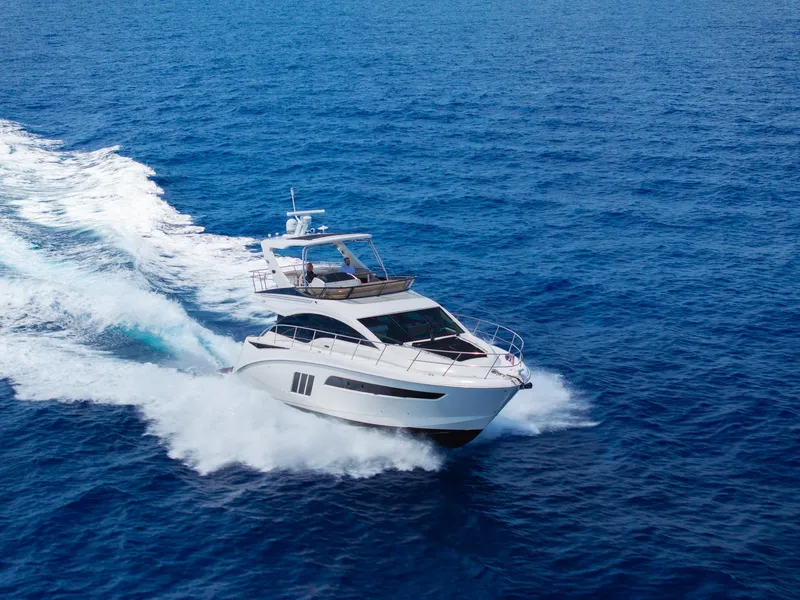 Slide: The Image of 2016 Sea Ray 510 Fly yacht cruising on open blue water. - 39