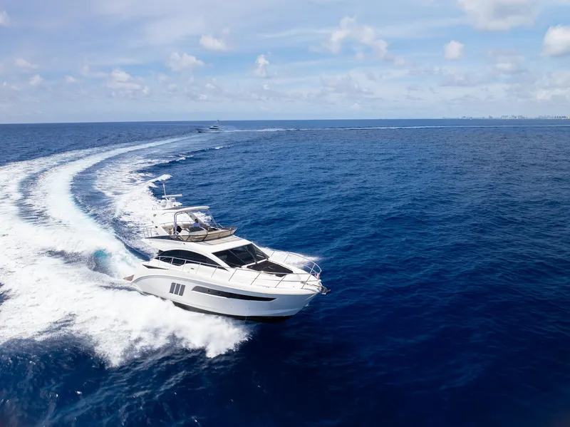 Slide: The Image of 2016 Sea Ray 510 Fly yacht cruising on open blue ocean. - 40