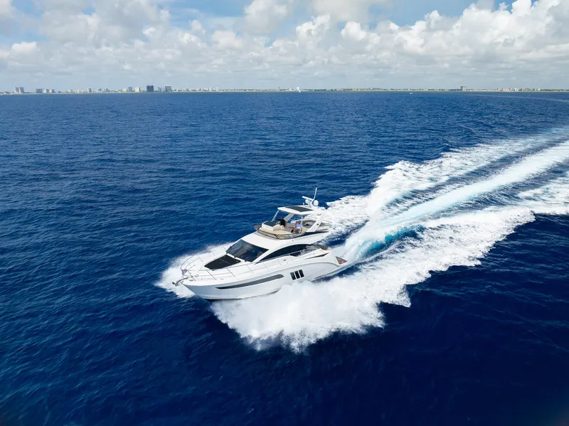 Slide: The Image of 2016 Sea Ray 510 Fly yacht cruising on open blue ocean. - 41