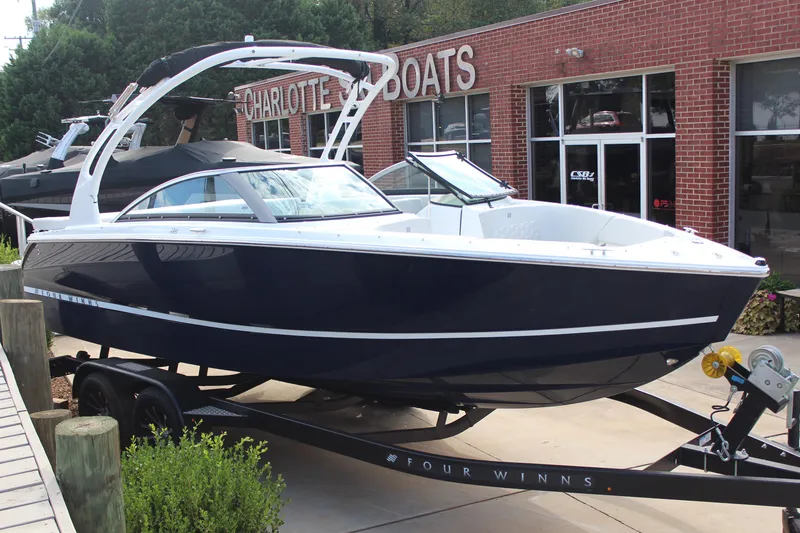 The Image of 2026 Four Winns H2 Freedom boat on trailer outside Charlotte Boats dealership. - 1