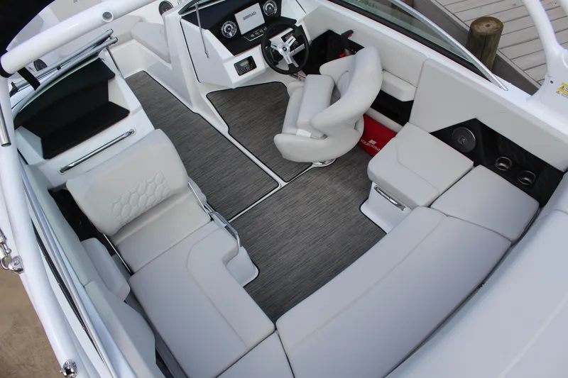 Slide: The Image of 2026 Four Winns H2 Freedom boat interior with sleek white seating and modern dashboard. - 12