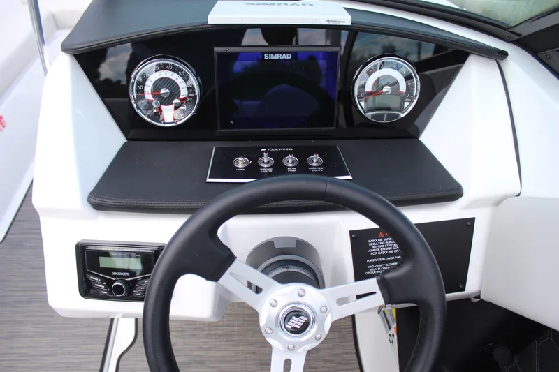 Slide: The Image of 2026 Four Winns H2 Freedom boat dashboard with steering wheel and control panel. - 14