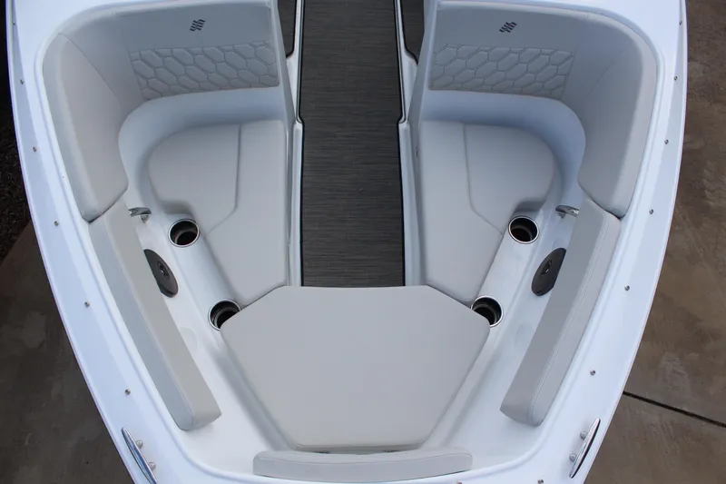 Slide: The Image of 2026 Four Winns H2 Freedom boat interior with cushioned seating and cup holders. - 17