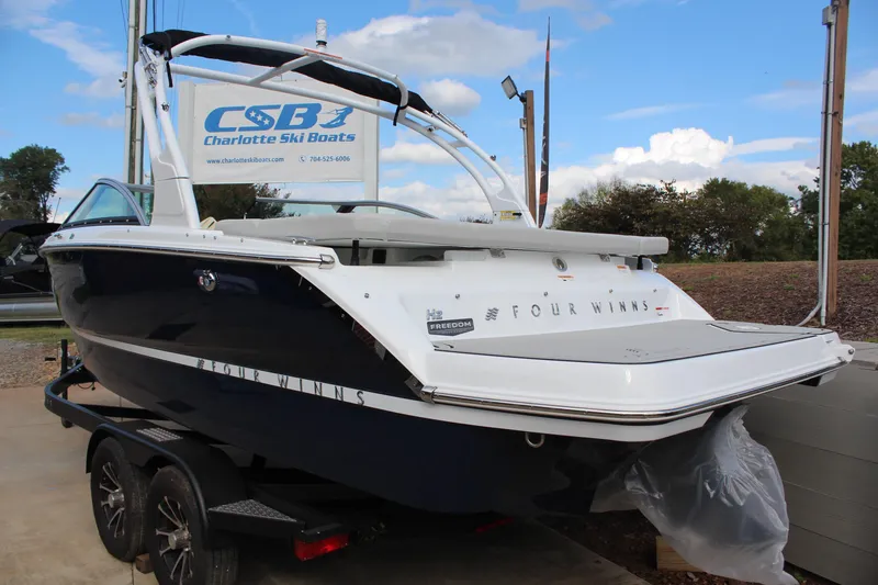 Slide: The Image of 2026 Four Winns H2 Freedom boat on trailer at Charlotte Ski Boats dealership. - 5