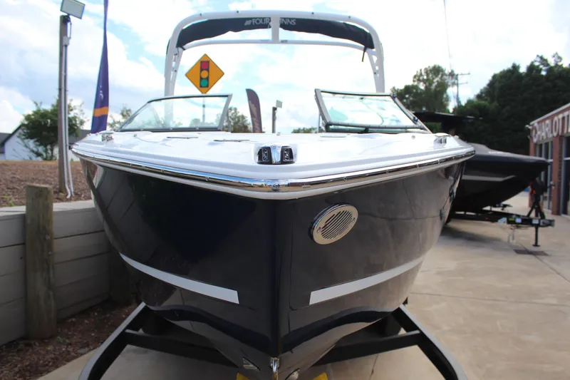 Slide: The Image of 2026 Four Winns H2 Freedom boat, sleek design, docked outdoors. - 8