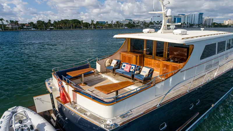 Slide: The Image of Luxurious 2006 Vicem 85 Classic yacht on serene waters, featuring elegant outdoor seating. - 13