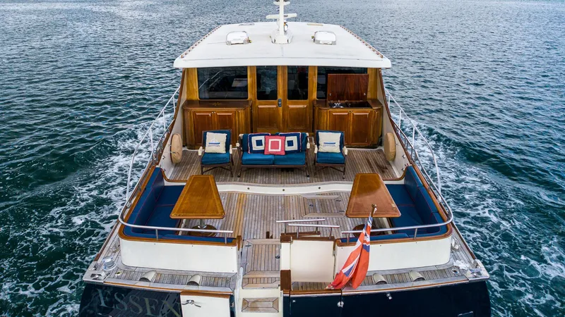Slide: The Image of Vicem 85 Classic 2006 yacht with elegant deck and seating, cruising on open water. - 17