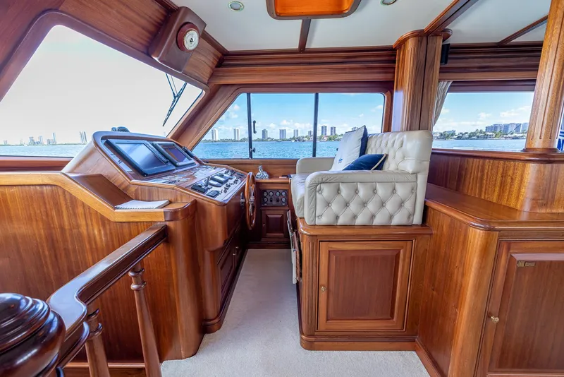 Slide: The Image of Luxurious 2006 Vicem 85 Classic yacht interior with wood paneling and plush seating. - 32