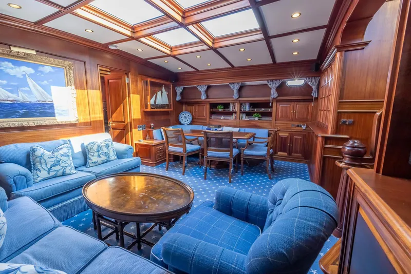 Slide: The Image of Luxurious interior of 2006 Vicem 85 Classic yacht with elegant wood paneling and plush blue seating. - 36