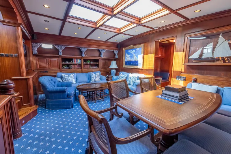Slide: The Image of Luxurious interior of 2006 Vicem 85 Classic yacht with elegant wood paneling and plush blue seating. - 37