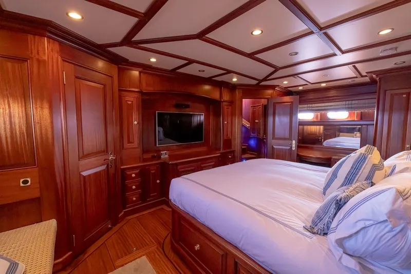 Slide: The Image of Luxurious wood-paneled bedroom interior of 2006 Vicem 85 Classic yacht with elegant furnishings. - 44