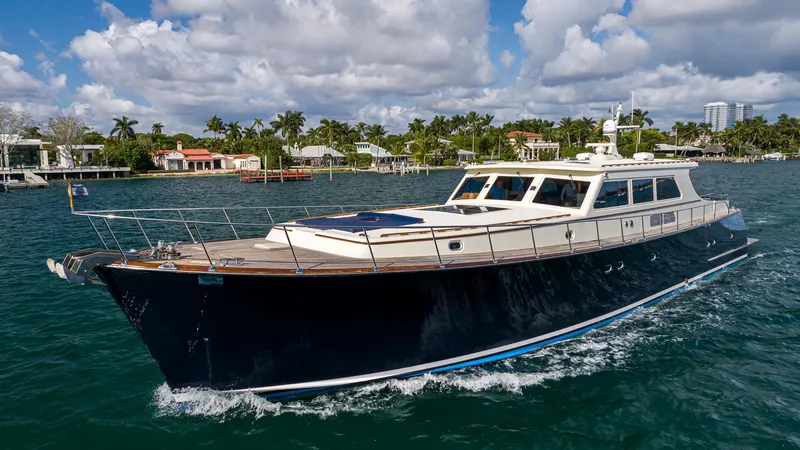 Slide: The Image of 2006 Vicem 85 Classic yacht cruising on a sunny day with coastal homes in the background. - 8