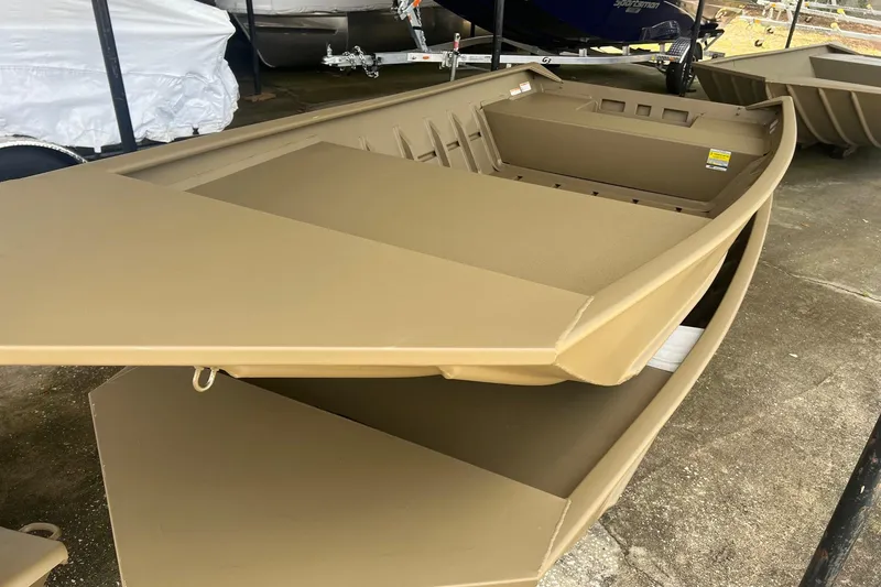 Slide: The Image of 2026 G3 Gator Tough 1436 boat, tan color, displayed outdoors on concrete. - 11